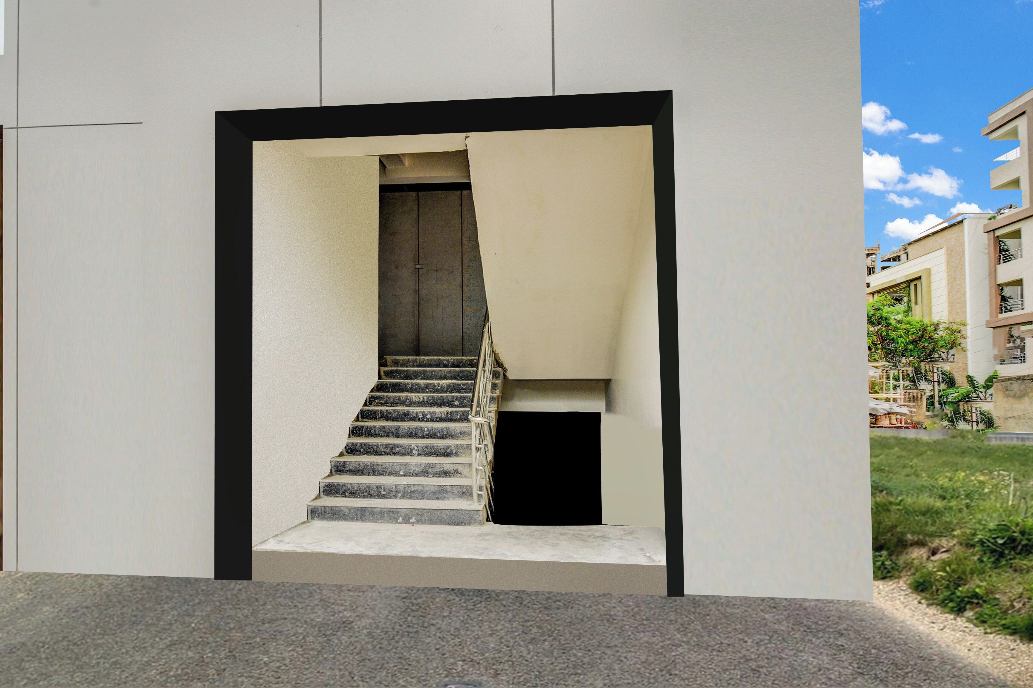 Una escalera conduce a un nivel superior, enmarcada por un diseño arquitectónico minimalista con fachada plana y borde negro.