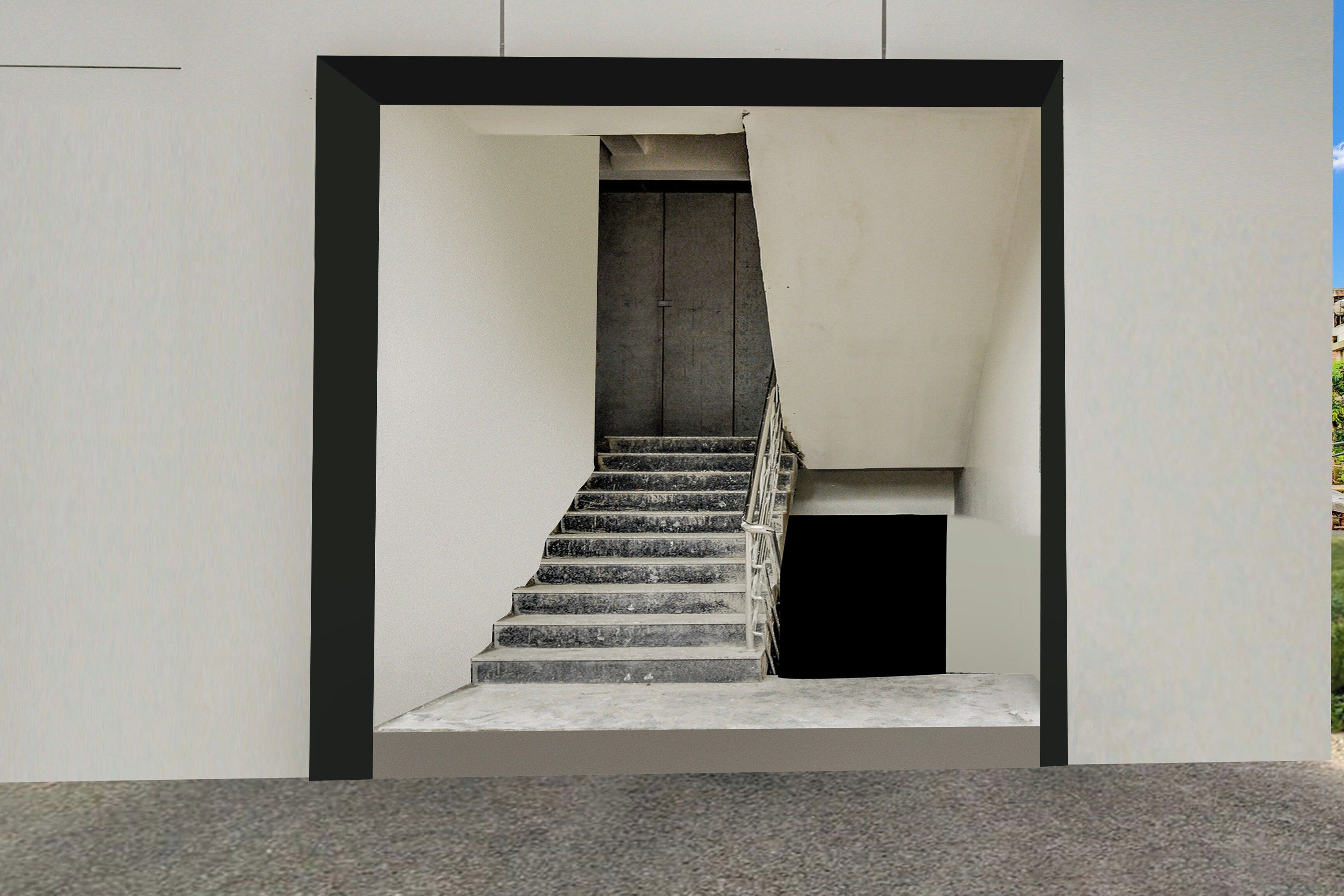 Una escalera que conduce a un nivel superior, delimitada por un muro blanco sencillo con un borde negro.
