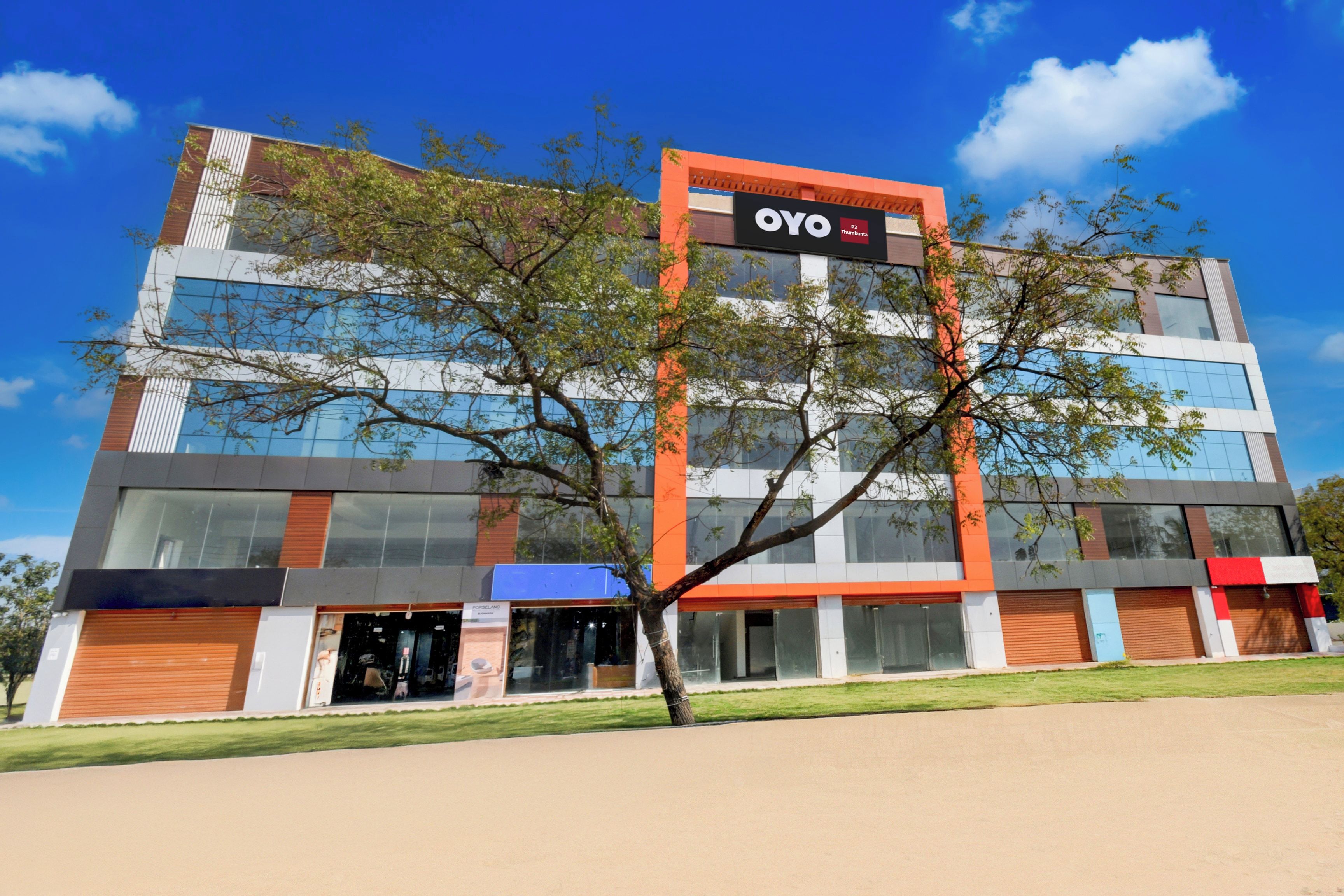 A modern building with a prominent sign for OYO.