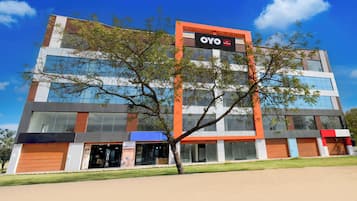 A modern building with a prominent sign for OYO.