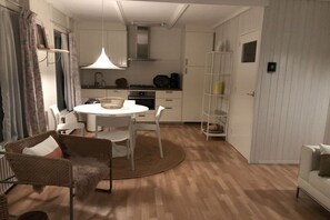 A compact living space with a dining area, kitchenette, and a white sofa. - Type B + "Zee, Bos en Duin" (Zoutelande)