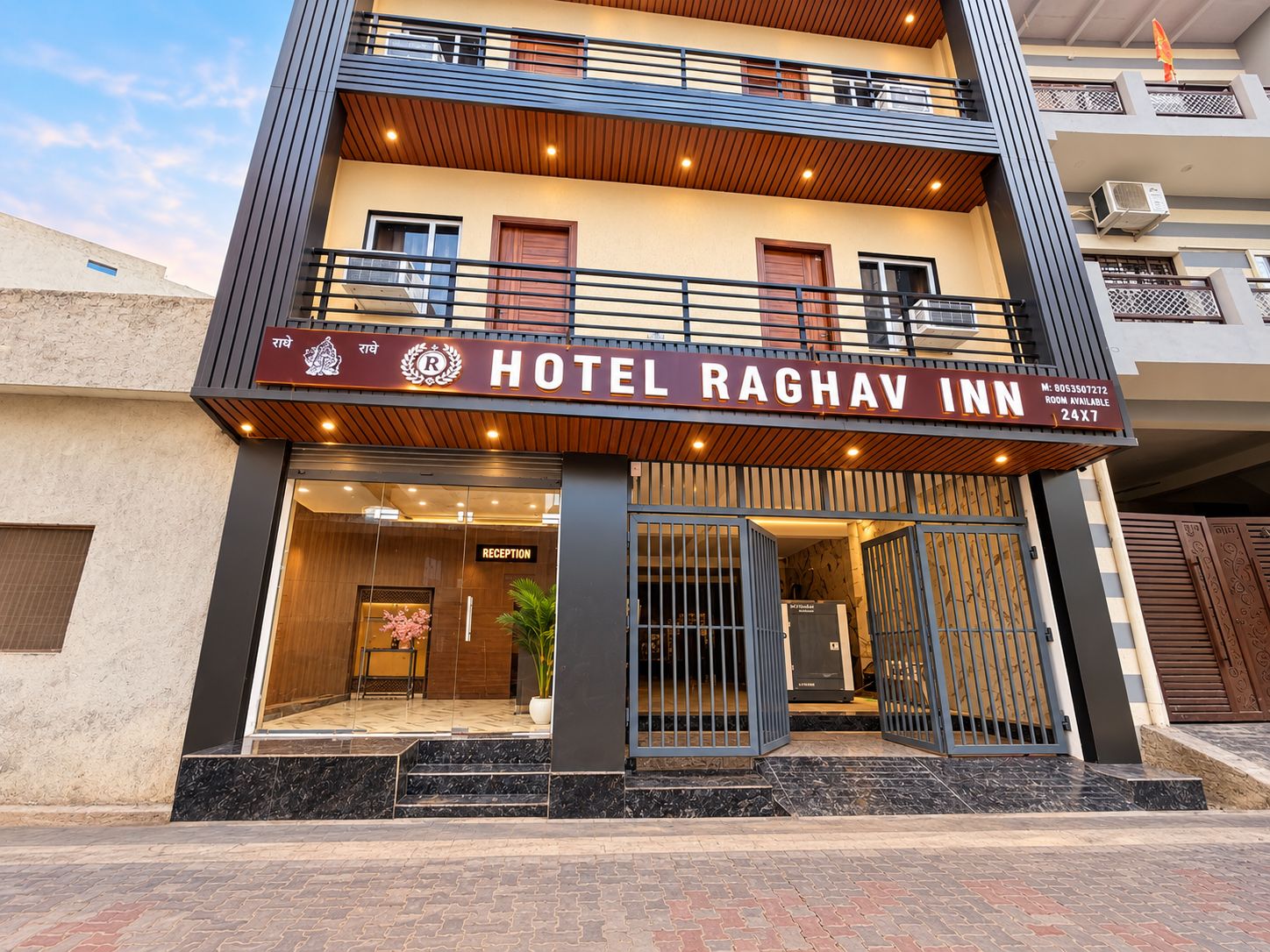A hotel with a reception area, a balcony, and a sign indicating room availability.