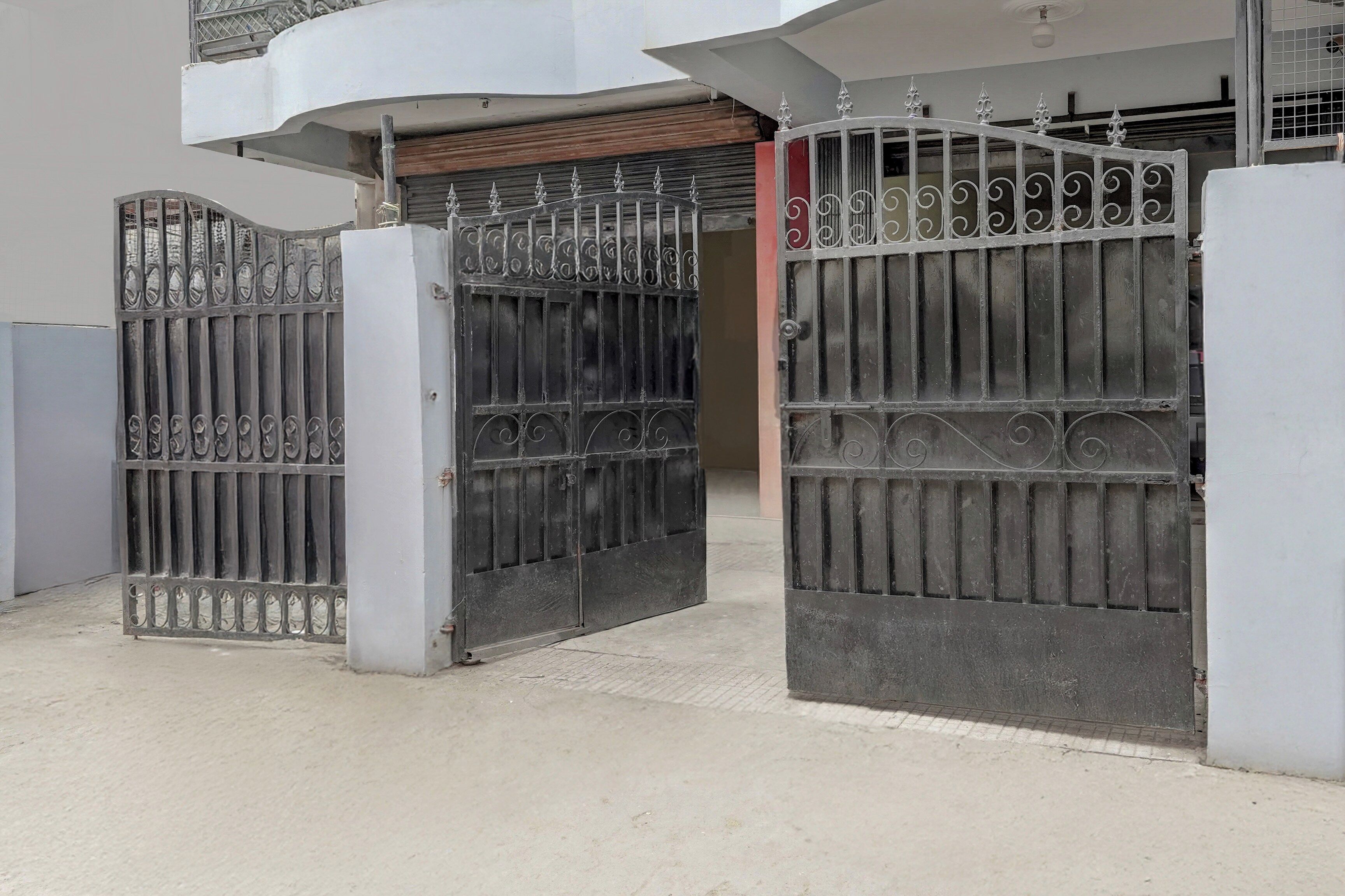 A gated entrance with a metal gate and a closed door.
