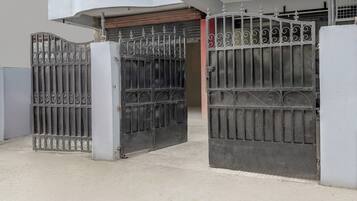 A gated entrance with a metal gate and a closed door.