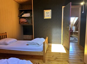 A wooden bunk bed with a white mattress, a wooden wardrobe, and a small framed picture on the wall. - Holiday Home 'La Régordane' with Mountain View, Pool and Spa in Solignac-sur-Loire (Solignac-sur-Loire)