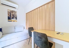 A modern room with a sofa, a wooden wardrobe, a desk, and a chair. - New! N&J - ROSSINI CHARM - Central - Balcony (Nice)