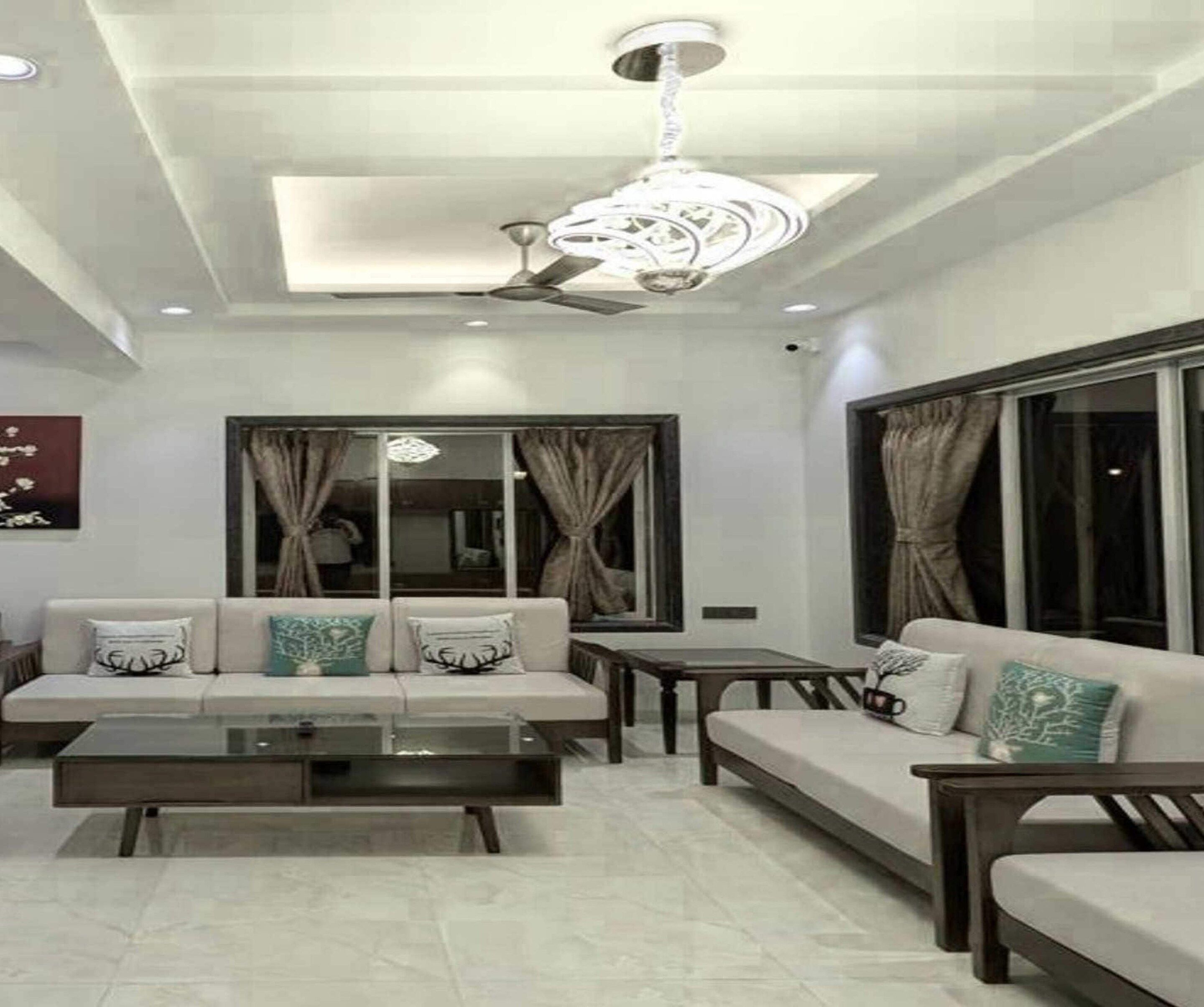 A modern living room with a sofa set, a coffee table, and a dining table.
