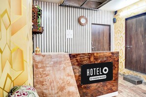 A reception desk with a sign indicating 'HOTEL' and 'Company-Serviced'. - Hotel O BLW Kakarmatta Near Banaras (Varanasi)