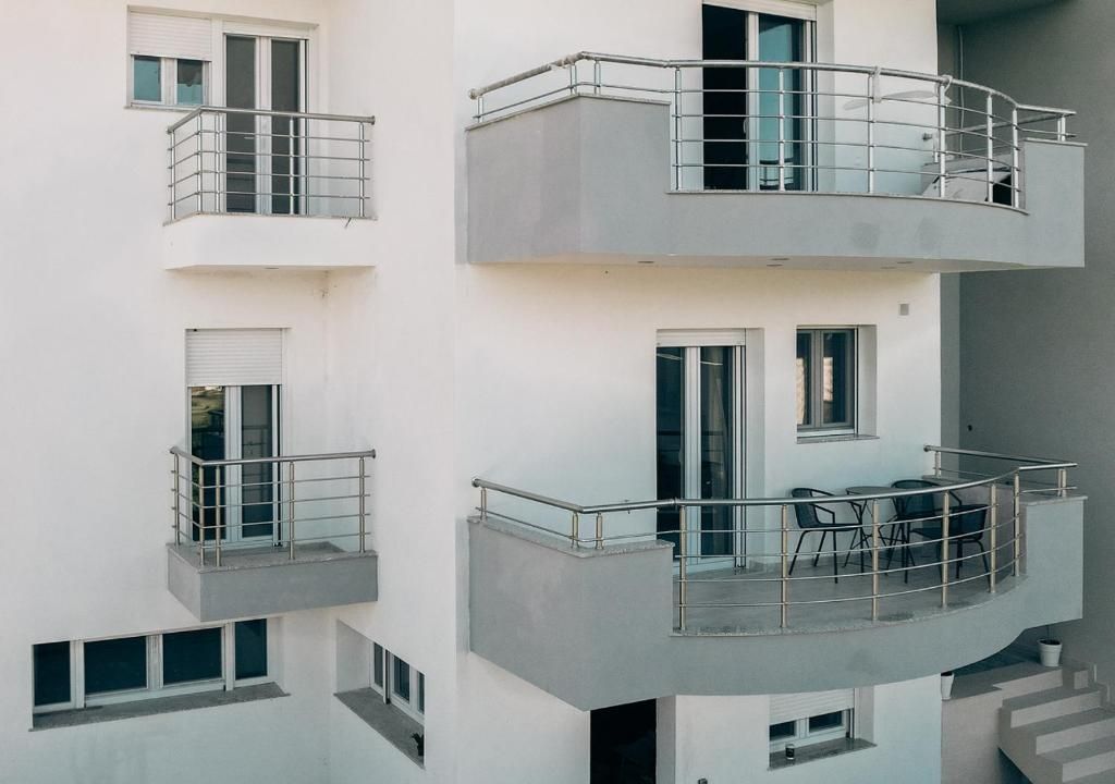 A multi-story building with balconies, windows, and a staircase.
