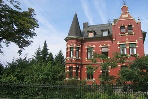 A large, red brick building with a prominent tower and multiple windows. - Holiday apartment with 1 bedroom (Koblenz)