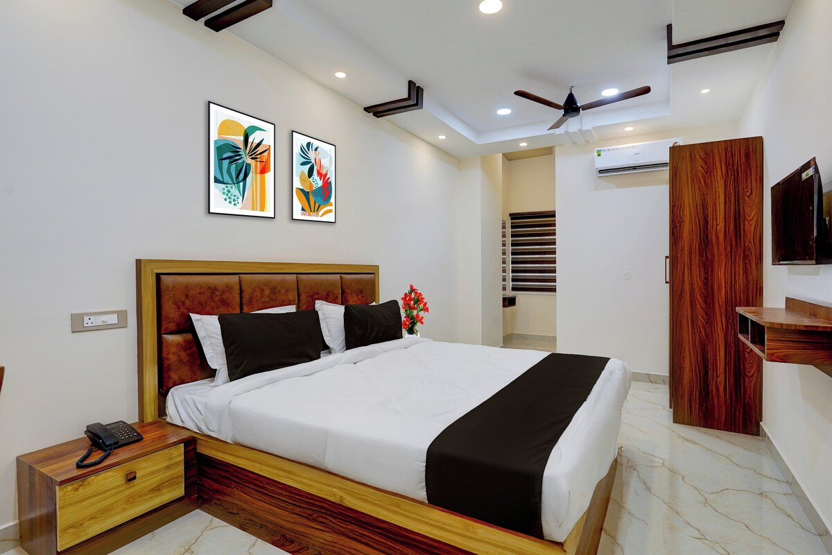 A modern bedroom with a bed, bedside table, and a telephone.