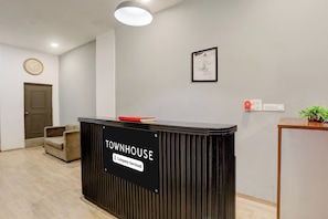 A reception desk labeled 'TOWNHOUSE' with a sign indicating 'Company-Serviced.'