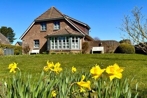A two-story brick house with a gabled roof and a front porch. - Holiday home in Nieblum with swimming pool (Nieblum)