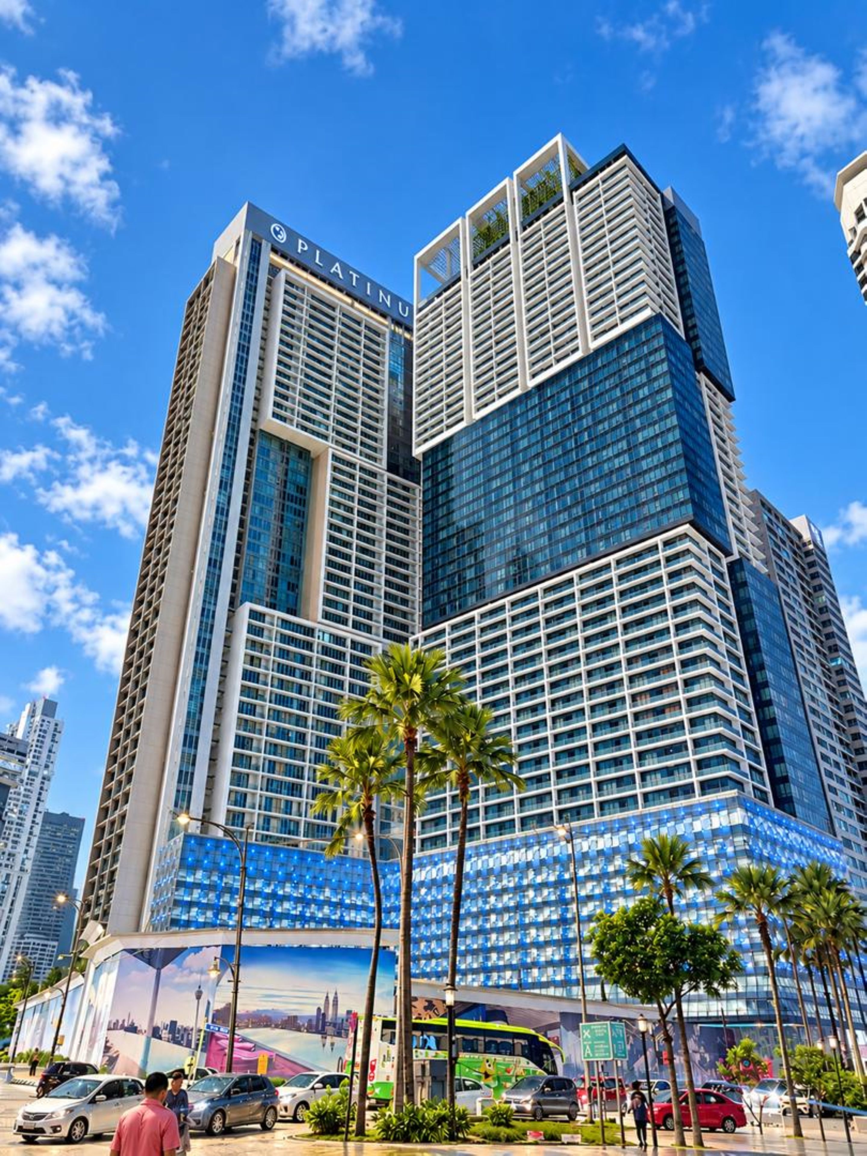 A high-rise building with a prominent sign reading 'PLATINUM' and a large glass facade.