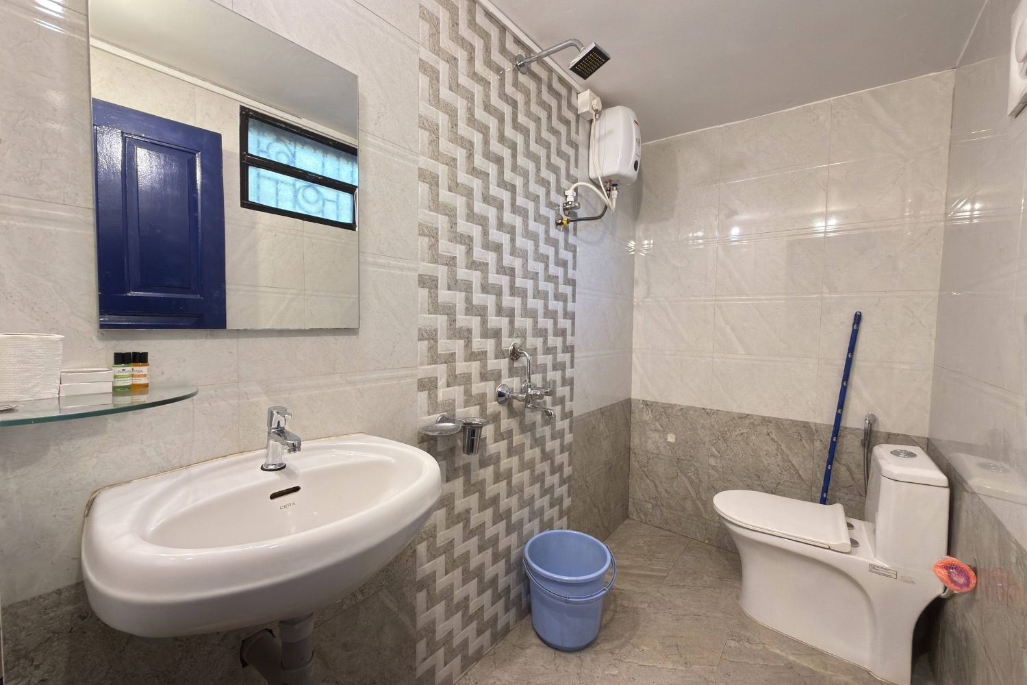A bathroom with a sink, toilet, and shower.