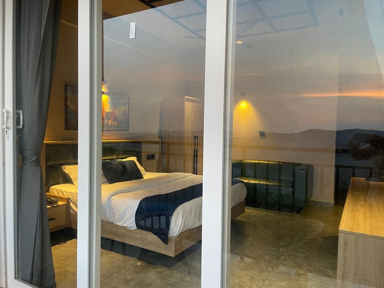 Una camera da letto moderna con un letto grande, una scrivania e vista sull'esterno.