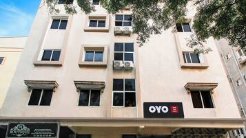 A multi-story building with a sign for 'OYO Hotel Tulsi Grand' on the facade.