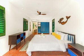 A hotel room with a bed, a desk, a wardrobe, and a decorative wall piece. - HÙA 03BR 301 (Đà Nẵng)