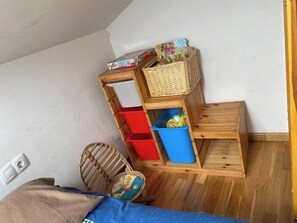 A room with a bunk bed, a small wooden table, and storage bins. - New Listing (Bronchales)
