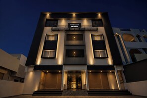 A modern two-story building with a sign indicating it is a serviced apartment. - Townhouse Kurnool Bus Terminal (Kurnool)