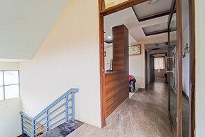 A staircase with a blue handrail leading to a wooden reception desk.