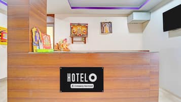 A hotel reception desk with a 'HOTEL' sign and a 'Company-Serviced' label.