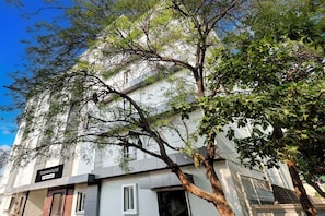 A building with a sign reading 'TOWNHOUSE' and 'OYO-Serviced'.