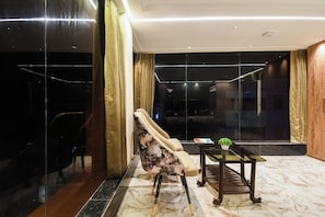A modern hotel lobby with a marble floor, a sofa, a coffee table, and a view of the interior. - Hotel O Krishna Regency (Krishnanagar)