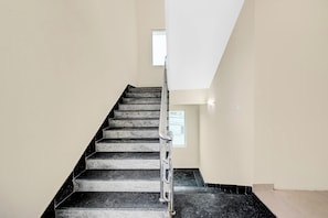 A staircase with a metal handrail leading to a landing. - Townhouse Suchitra IDA Jeedimetla (Hyderabad)