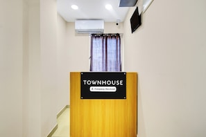 A wooden podium with a sign that reads 'TOWNHOUSE Company-Serviced.' - Townhouse Suchitra IDA Jeedimetla (Hyderabad)