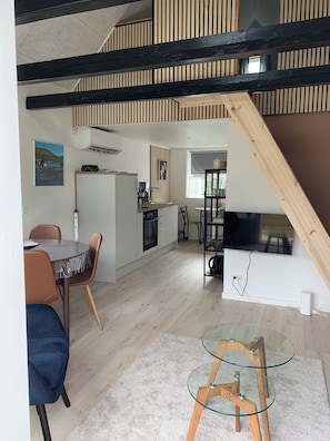 A modern interior with a dining area, kitchen, and living space.