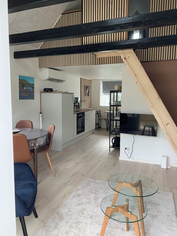A modern interior with a dining area, kitchen, and living space.