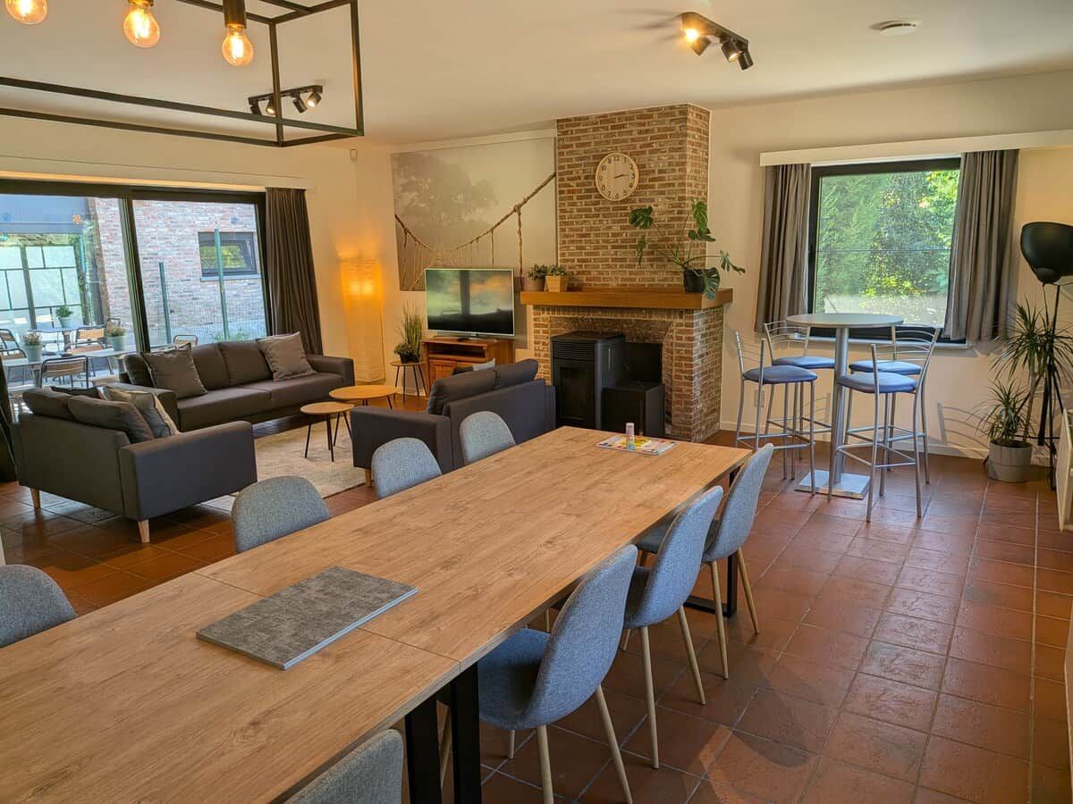 A spacious living area with a fireplace, a dining table, and comfortable seating.