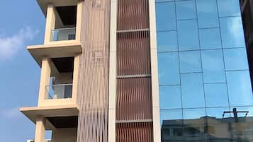 Un edificio de hotel con fachada moderna, varios balcones y un letrero llamativo para Narayan Grand Hotel.