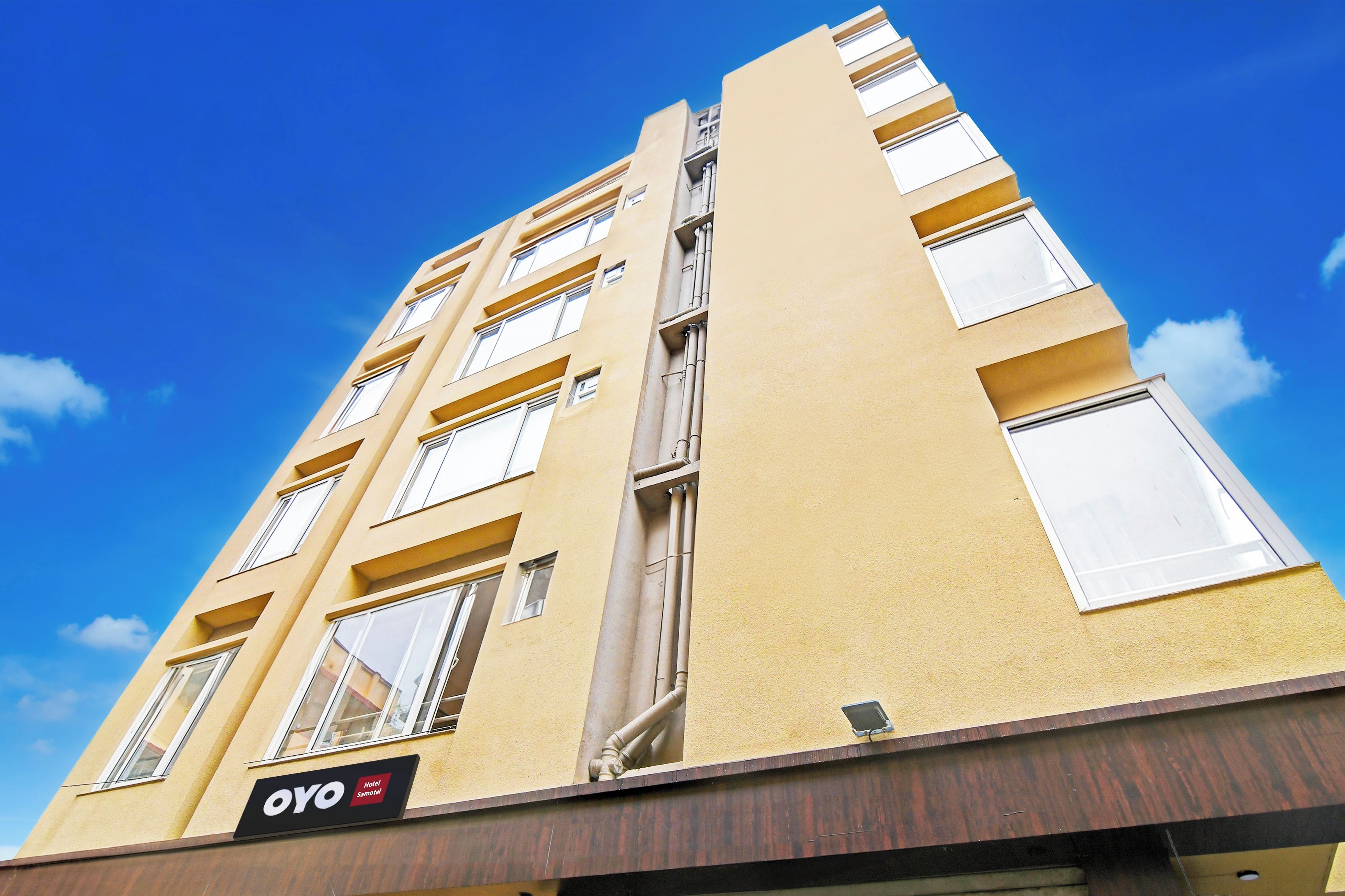 A multi-story hotel building with a clear sky.