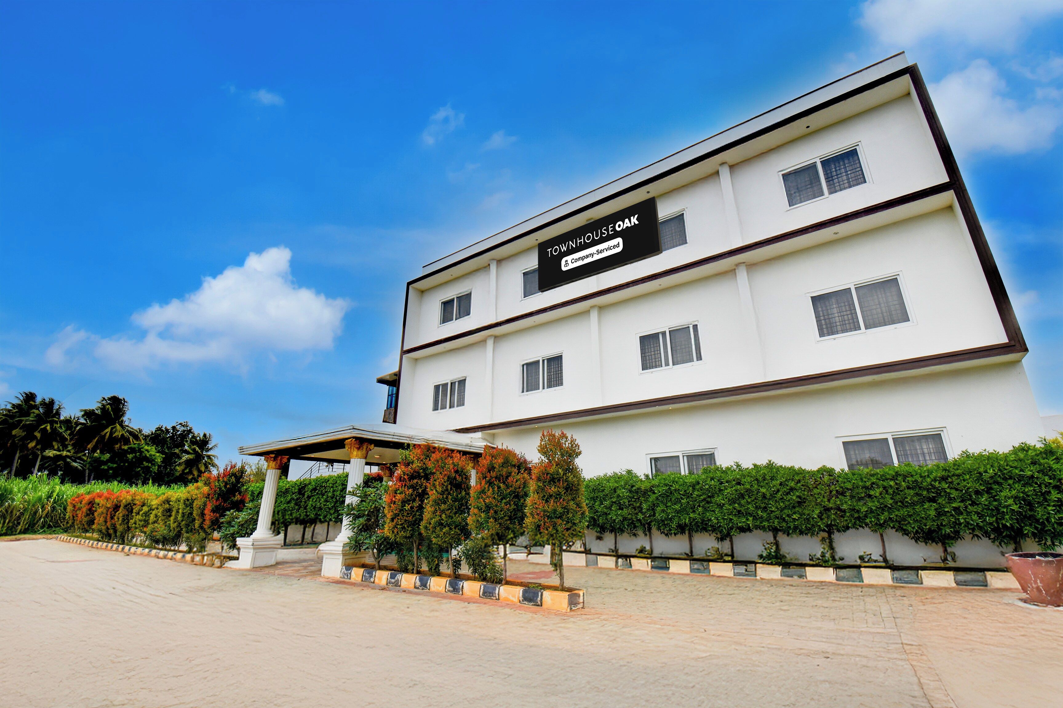 A two-story building with a sign indicating it is a company-serviced property.