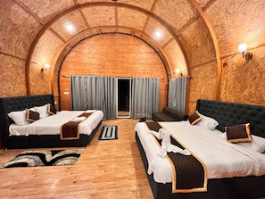 A room with two beds, a wooden ceiling, and a view through a door. - Streamedge Resort (sakleshpur)