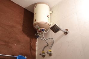 A water heater with a control panel and a showerhead attached to it. - Maati Heritage Homestay (Jodhpur)