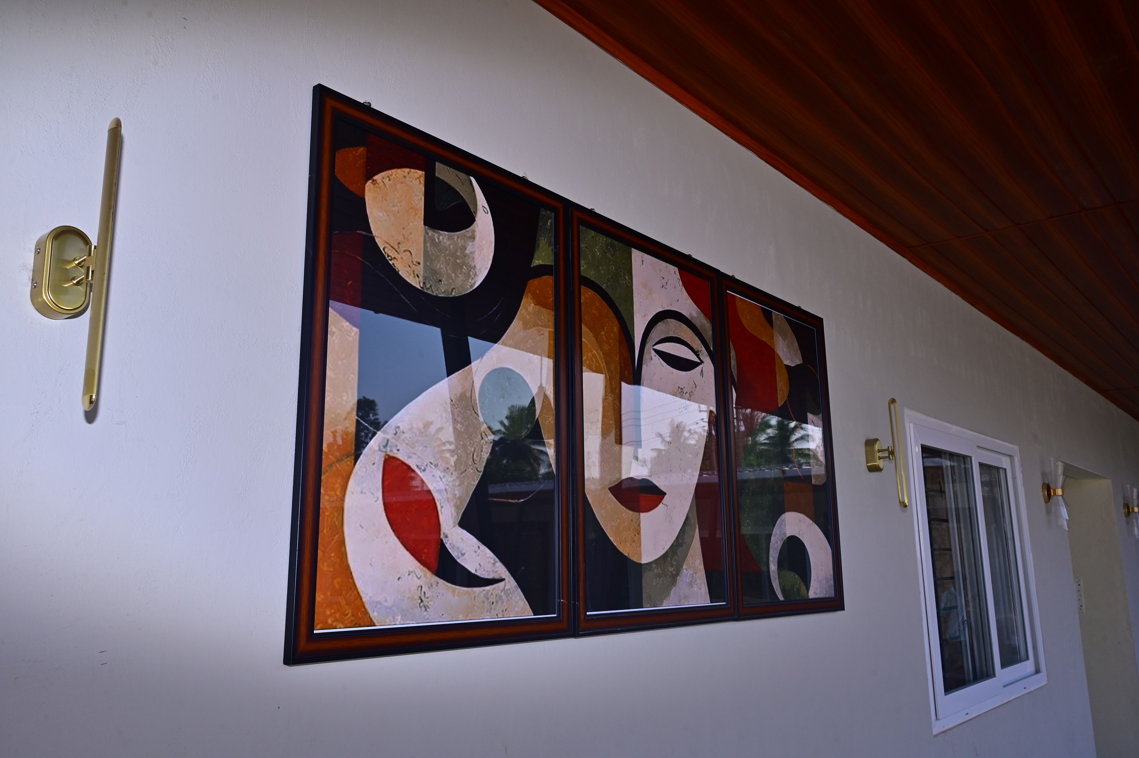 Paredes com arte abstrata e uma porta com puxador de latão.