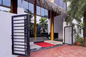 A gated entrance with a red carpet leading to a staircase.