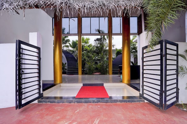 A gated entrance with a red carpet leading to a staircase.