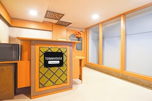 A reception desk with a sign reading 'TOWNHOUSE Company-Serviced.'