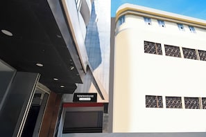 A building with a sign reading 'TOWNHOUSE' and a company-serviced logo.