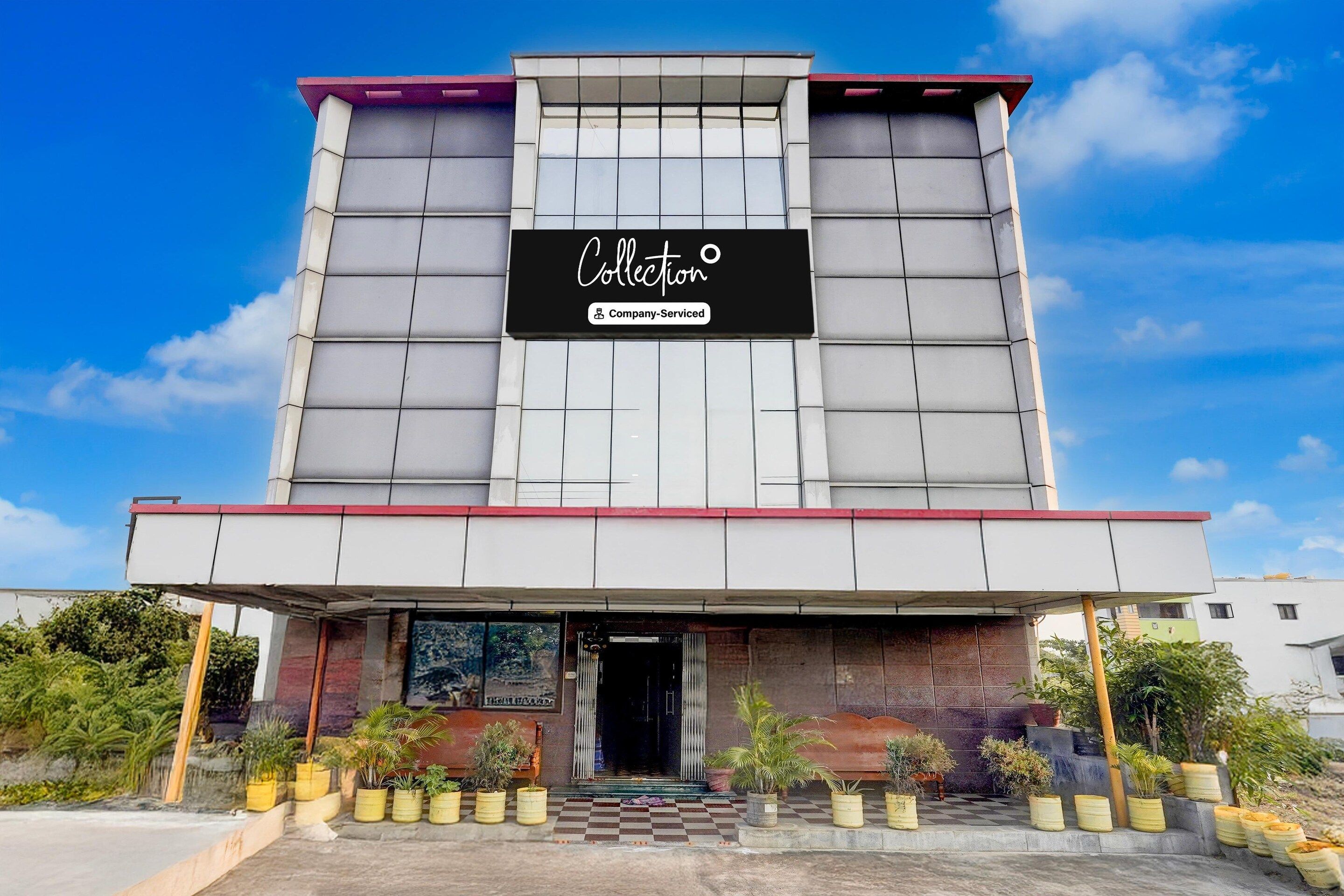 A modern building with a sign reading "Collection" and a company-serviced logo.