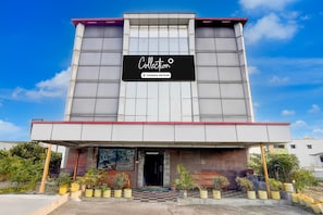A modern building with a sign reading "Collection" and a company-serviced logo.