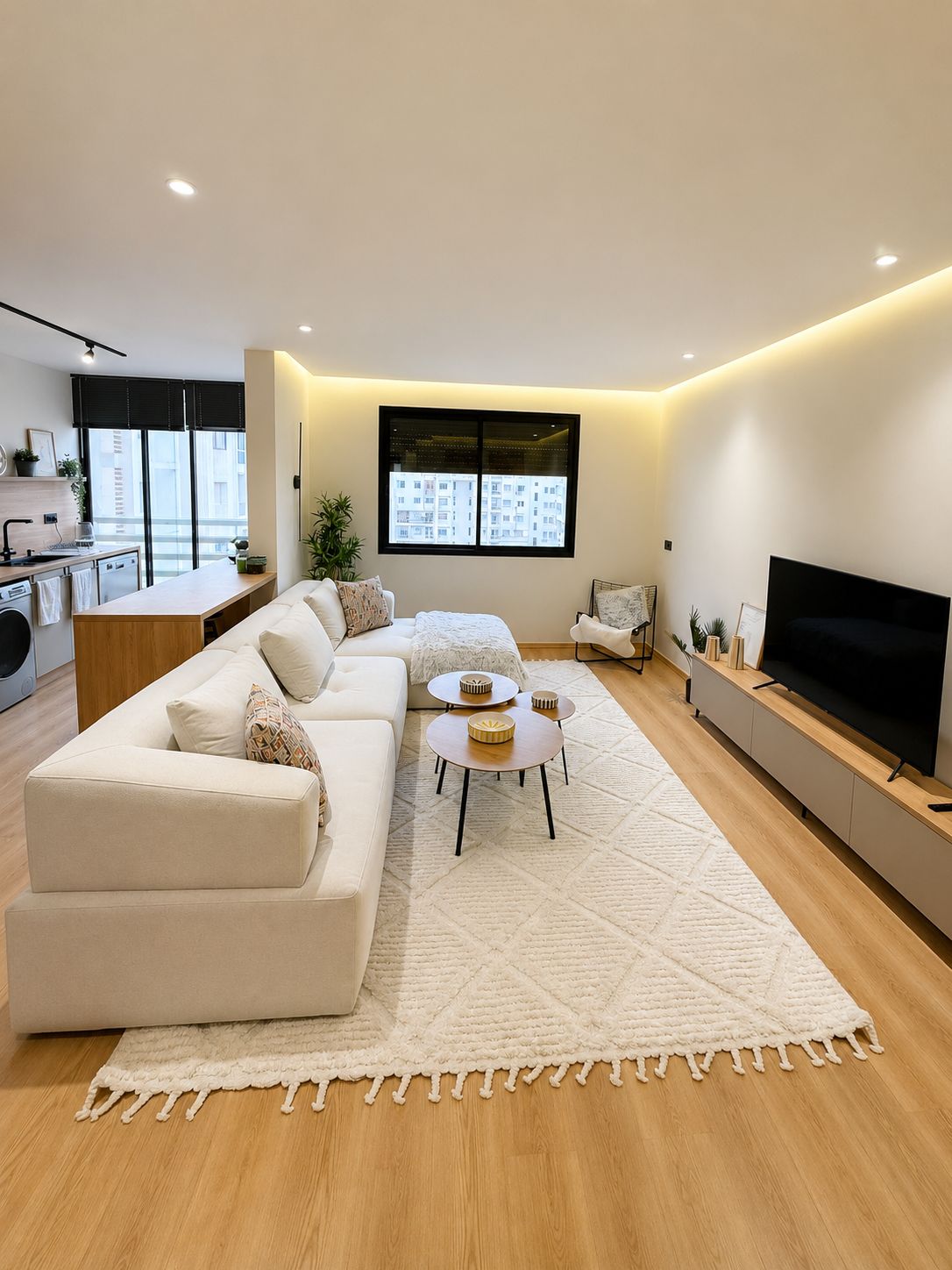 A modern living room with a sofa, coffee table, and TV.