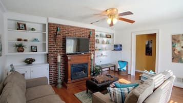 A living room with a fireplace, television, and seating area.