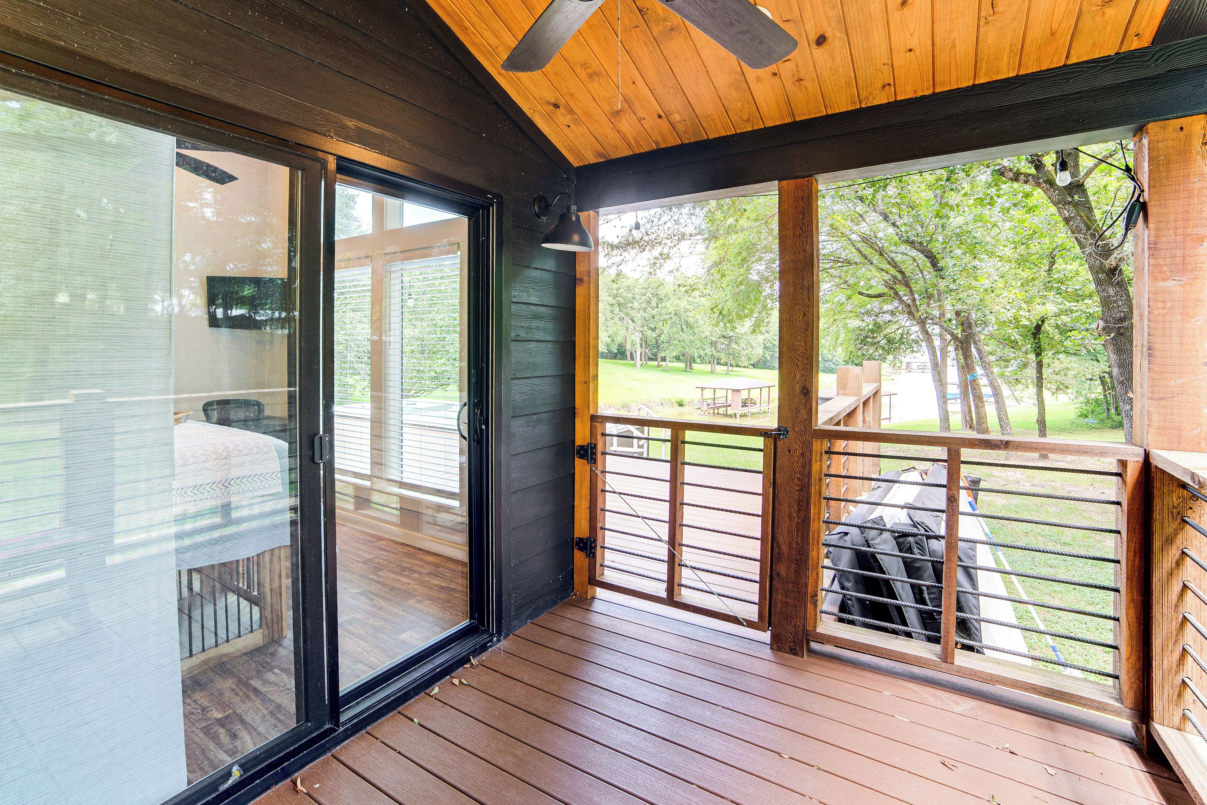 A wooden deck with a glass door leading to an outdoor area.