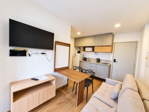 A compact living space with a kitchenette, a dining area, and a seating area. - New Listing (São Paulo)