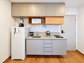 A compact kitchen with a refrigerator, microwave, coffee maker, and a sink. - New Listing (São Paulo)